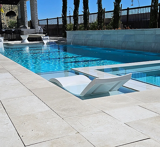 Modern pool lounge area by Clarity Pools